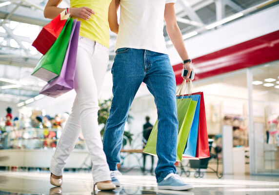 Legs of young couple going in the mall